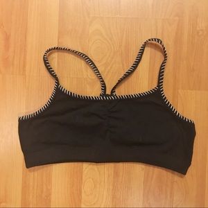 Black jersey sports bra with white stitching